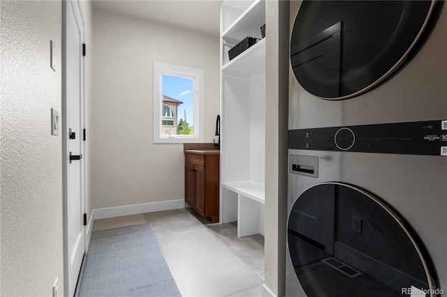 10 Summit Ash, Littleton, CO 80127 - washroom featuring stacked washer / drying machine and baseboards