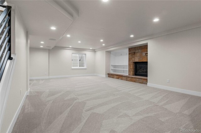 10 Summit Ash, Littleton, CO 80127 - unfurnished living room with light carpet, baseboards, recessed lighting, crown molding, and a fireplace