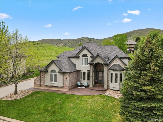 10 Summit Ash, Littleton, CO 80127 - french country style house featuring a mountain view and a front yard