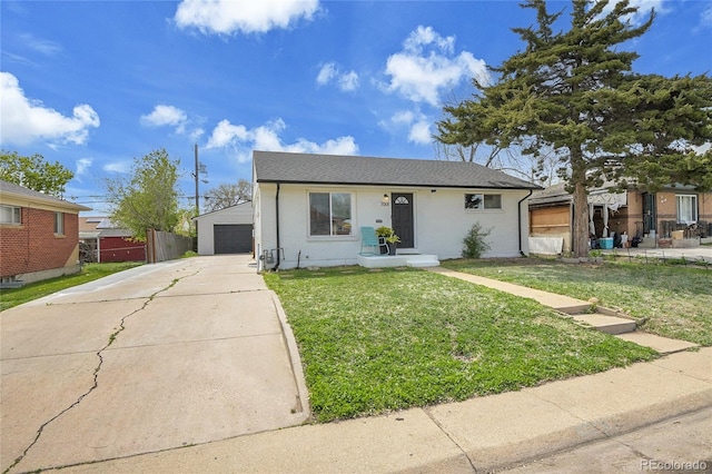 view of front facade with a front lawn, an outbuilding, and a detached garage