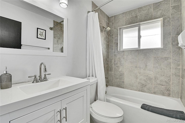 bathroom featuring vanity, toilet, and shower / tub combo