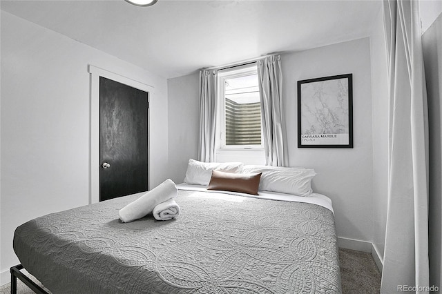 carpeted bedroom featuring baseboards