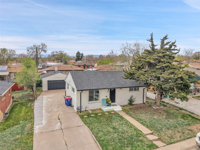 single story home with a shingled roof, a residential view, a front yard, and a detached garage