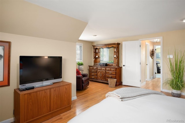 bedroom with baseboards and light wood-type flooring