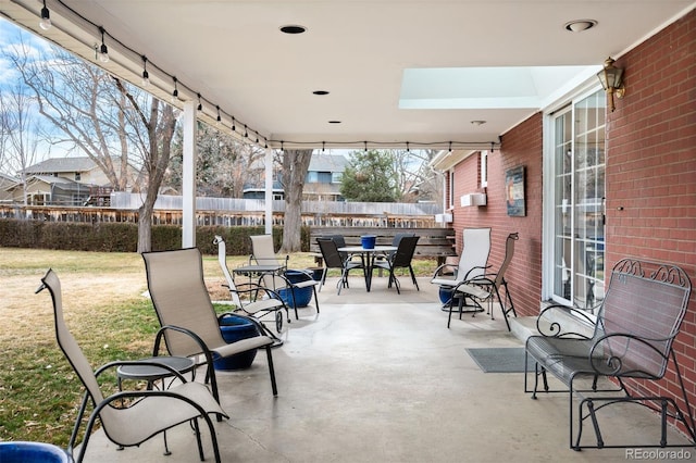 view of patio / terrace with outdoor dining area and fence