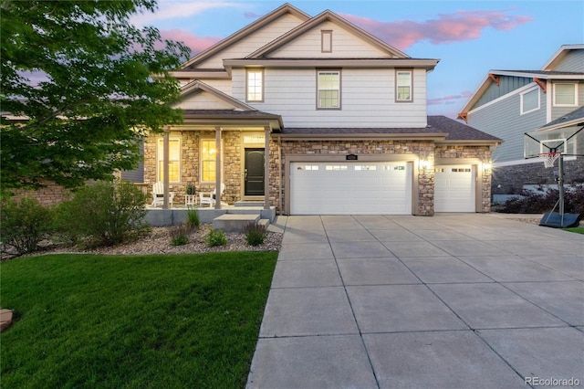 6236 S Millbrook Way, Aurora, CO 80016 - view of front facade featuring driveway, a garage, a front yard, and stone siding