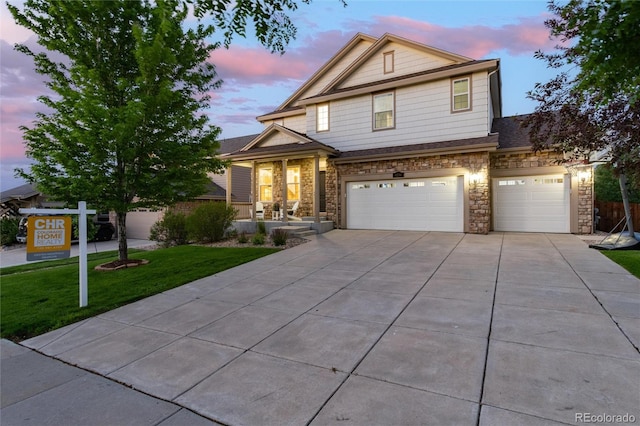 6236 S Millbrook Way, Aurora, CO 80016 - view of front of home featuring driveway, a lawn, a garage, and stone siding