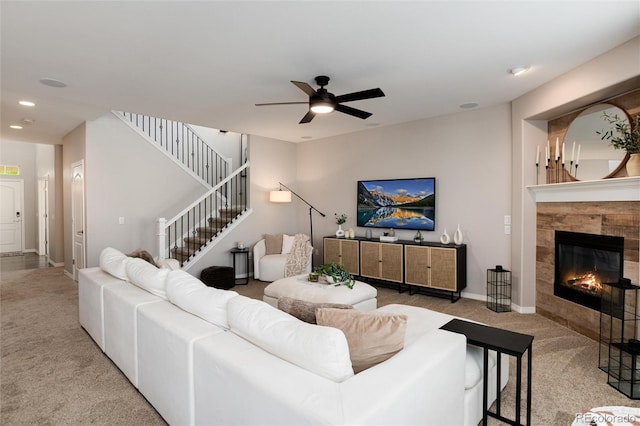 6236 S Millbrook Way, Aurora, CO 80016 - living area featuring carpet flooring, a ceiling fan, recessed lighting, a tiled fireplace, and stairs