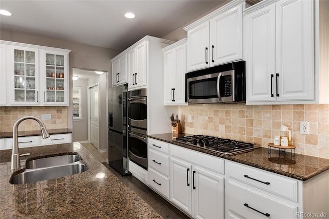 6236 S Millbrook Way, Aurora, CO 80016 - kitchen featuring stainless steel appliances, white cabinetry, recessed lighting, glass insert cabinets, and dark stone countertops