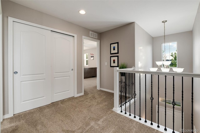 6236 S Millbrook Way, Aurora, CO 80016 - hallway featuring carpet, an upstairs landing, recessed lighting, and a chandelier