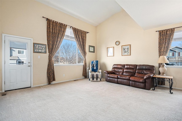 living room with carpet, a healthy amount of sunlight, and baseboards