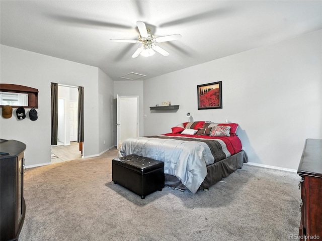 bedroom with light colored carpet, a ceiling fan, and attic access