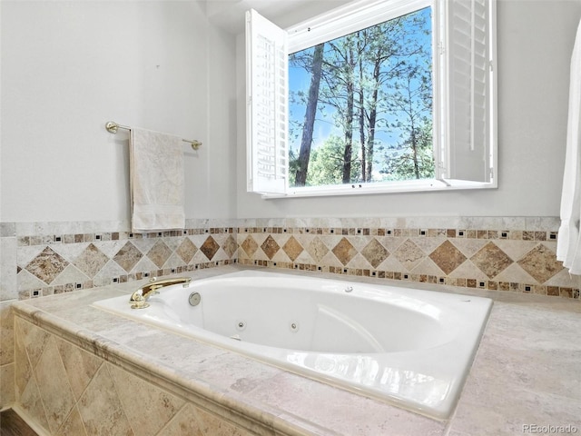 bathroom featuring a tub with jets