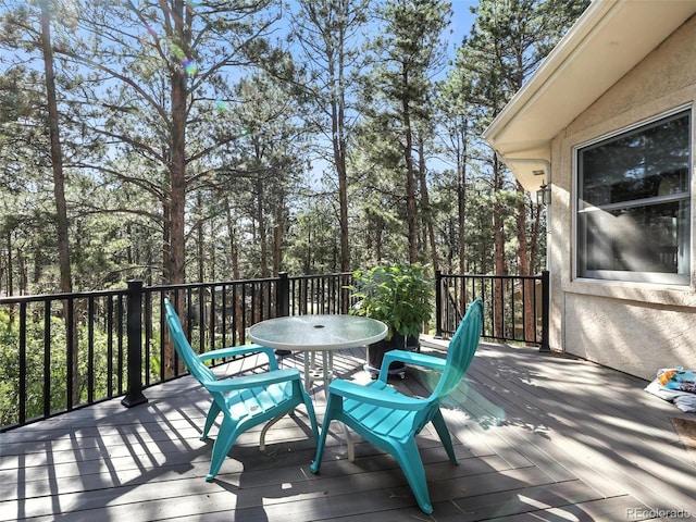 wooden terrace featuring outdoor dining area