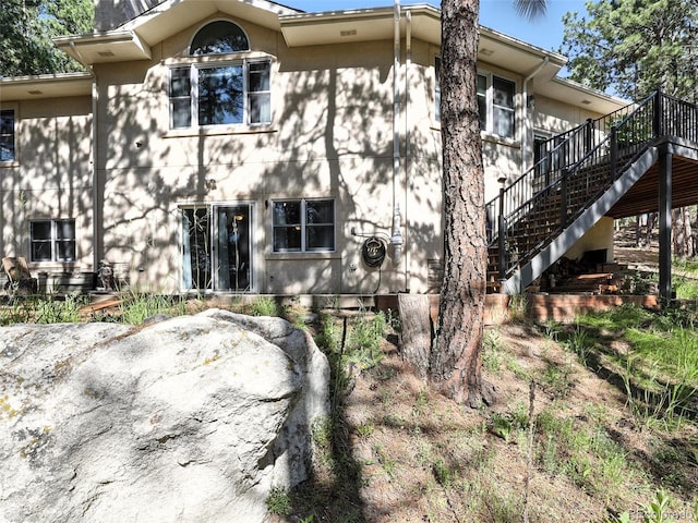 view of front facade featuring stairs and a deck