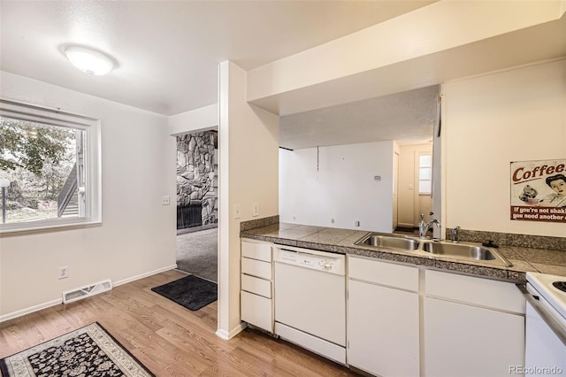 2604 S Xanadu Way Unit B, Aurora, CO 80014 - kitchen featuring dishwasher, a sink, tile countertops, and light wood finished floors