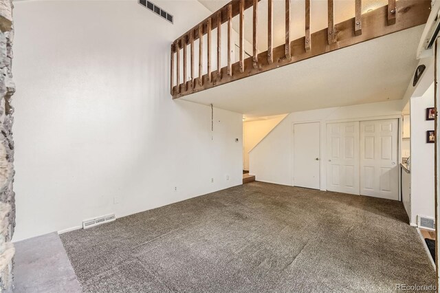 2604 S Xanadu Way Unit B, Aurora, CO 80014 - unfurnished living room with carpet floors and stairway