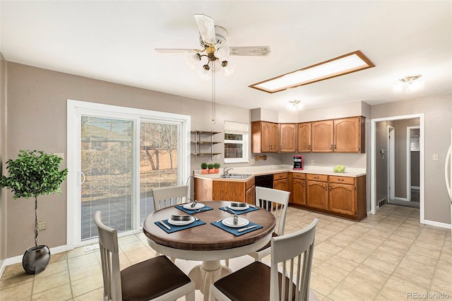 kitchen featuring black dishwasher, sink, and ceiling fan