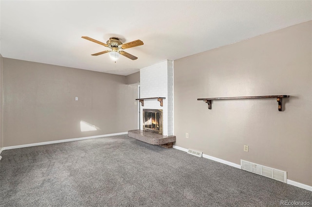 unfurnished living room featuring ceiling fan, carpet flooring, and a brick fireplace