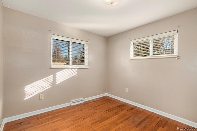 empty room featuring hardwood / wood-style flooring and plenty of natural light