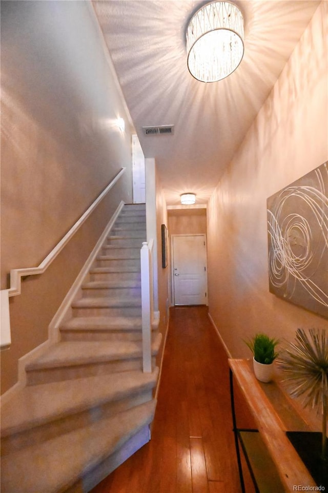 stairs featuring hardwood / wood-style flooring