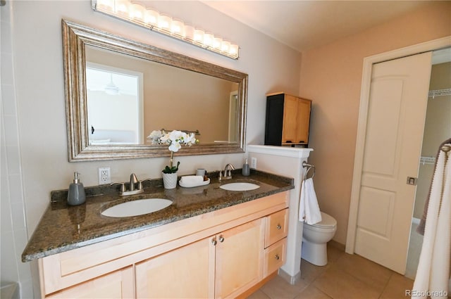 bathroom with tile patterned flooring, vanity, and toilet