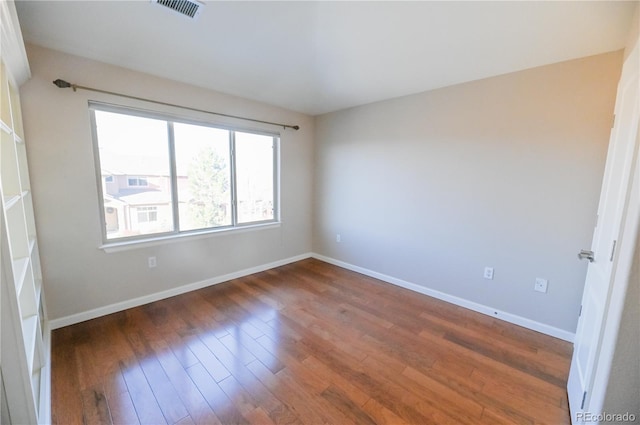 spare room featuring dark hardwood / wood-style flooring