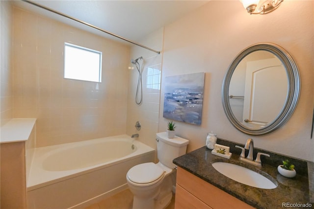 full bathroom with vanity, tiled shower / bath combo, and toilet