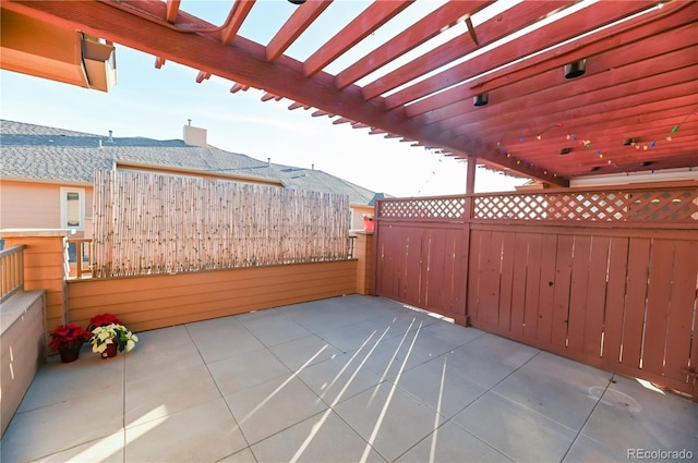 view of patio / terrace featuring fence and a pergola