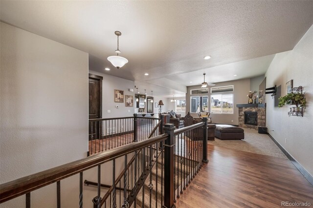 corridor featuring hardwood / wood-style flooring and a textured ceiling