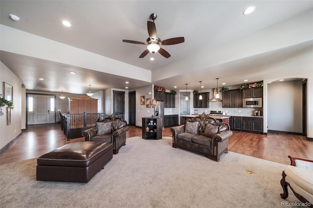 living room featuring wood-type flooring and ceiling fan