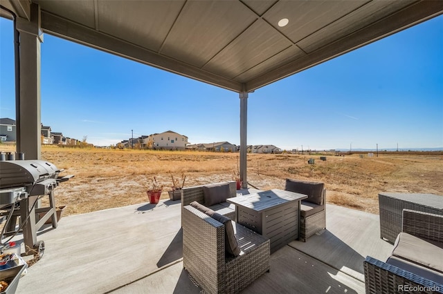 view of patio / terrace featuring grilling area, an outdoor hangout area, and a rural view