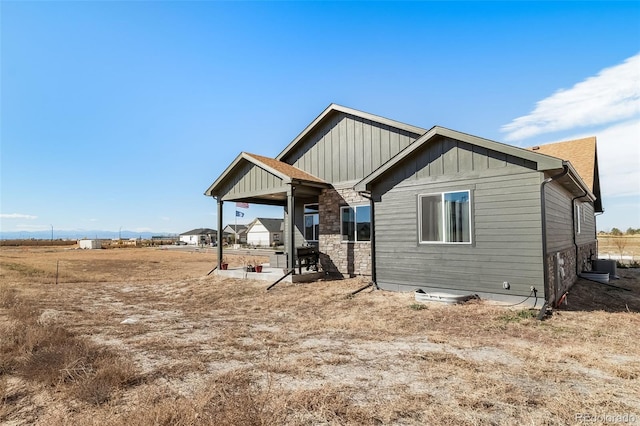 back of property featuring central AC