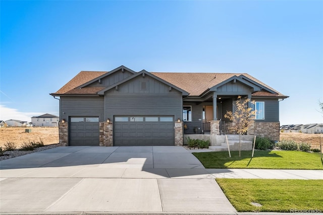 craftsman-style home with a garage and a front lawn