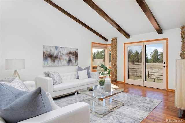 living room with lofted ceiling with beams and wood finished floors