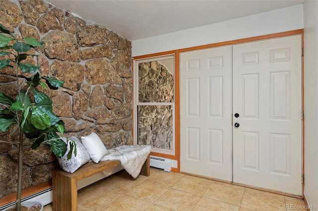 entrance foyer with light tile patterned floors and baseboard heating