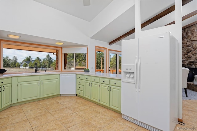 kitchen featuring vaulted ceiling with beams, green cabinets, light tile patterned floors, white appliances, and a sink