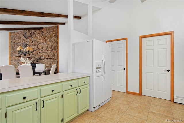 kitchen featuring light countertops, light tile patterned floors, beam ceiling, white fridge with ice dispenser, and green cabinetry