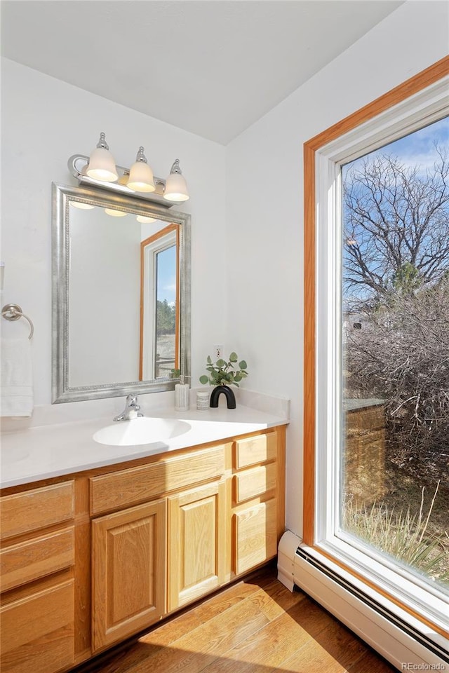 bathroom with baseboard heating and vanity