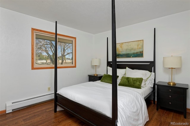 bedroom featuring baseboard heating and wood finished floors