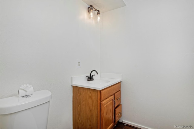 bathroom with toilet and vanity