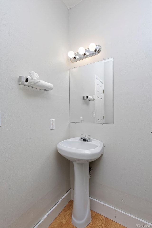 bathroom featuring baseboards and wood finished floors