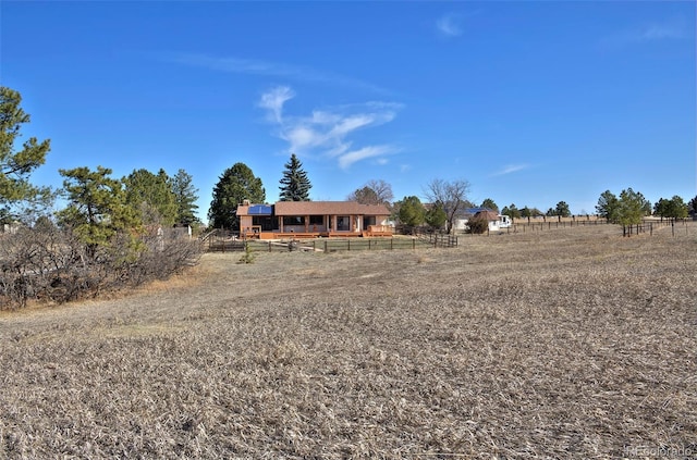 view of yard with a rural view and fence