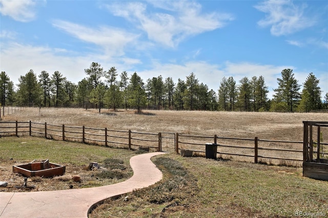 view of yard featuring a rural view and fence