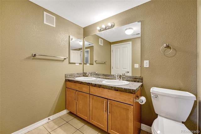 bathroom with tile patterned floors, vanity, and toilet