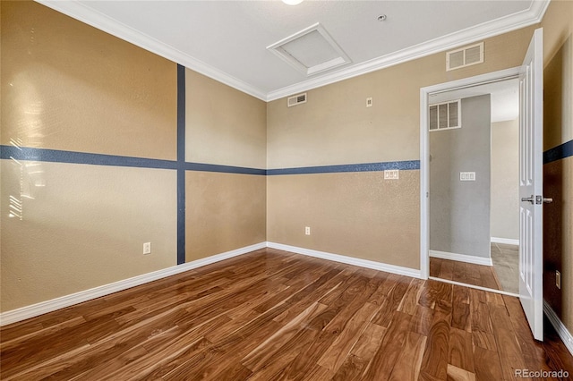 unfurnished room featuring hardwood / wood-style floors and crown molding