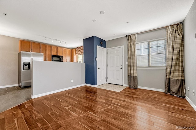 unfurnished living room featuring light wood-type flooring