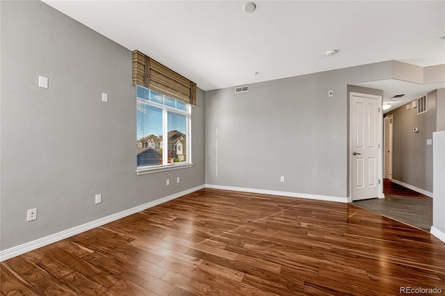 unfurnished room featuring dark wood-type flooring