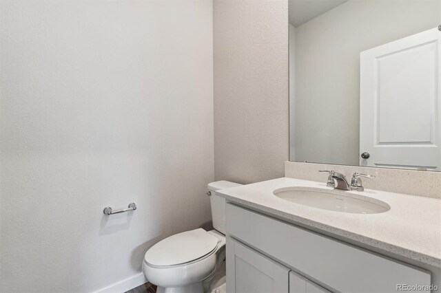 bathroom featuring vanity and toilet