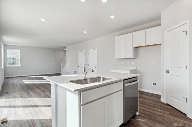 kitchen with sink, stainless steel dishwasher, dark hardwood / wood-style floors, a center island with sink, and white cabinets